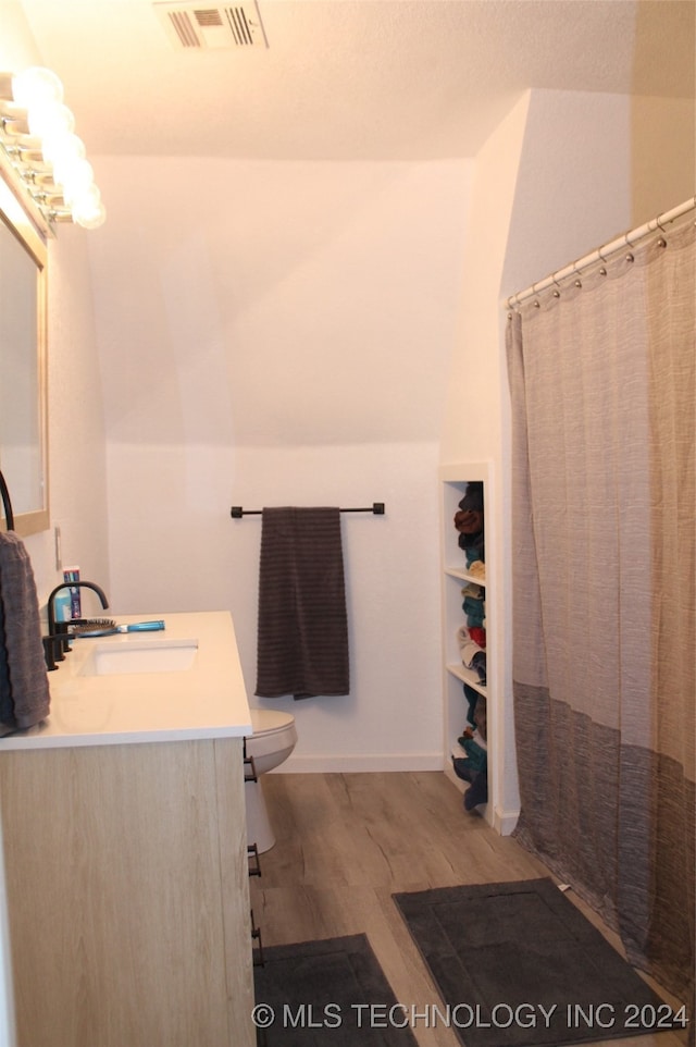 bathroom with toilet, vanity, hardwood / wood-style floors, and a shower with shower curtain