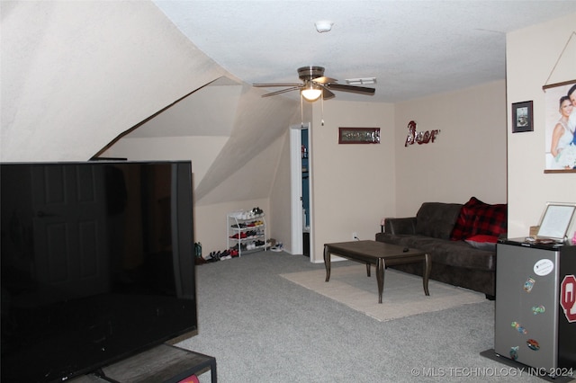 carpeted living room featuring ceiling fan and a textured ceiling