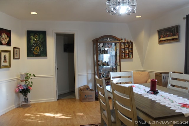 dining room with light hardwood / wood-style flooring and a chandelier