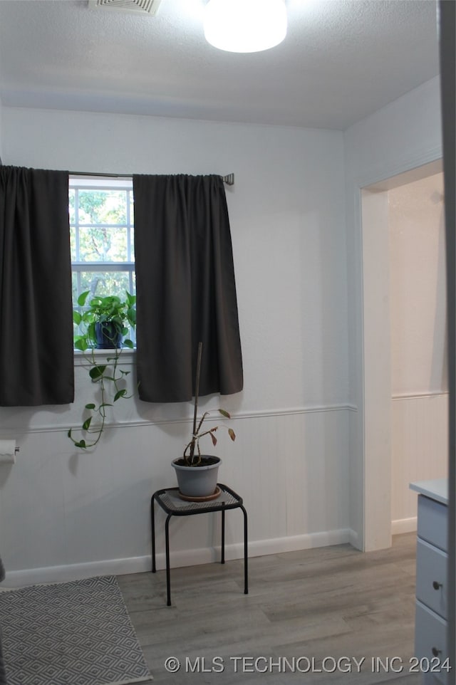 bedroom with hardwood / wood-style floors and a textured ceiling