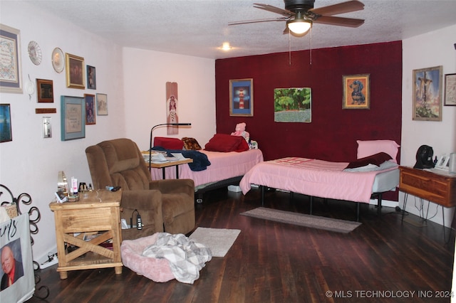 bedroom featuring ceiling fan, hardwood / wood-style floors, and a textured ceiling