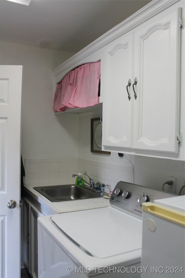 washroom featuring sink and cabinets