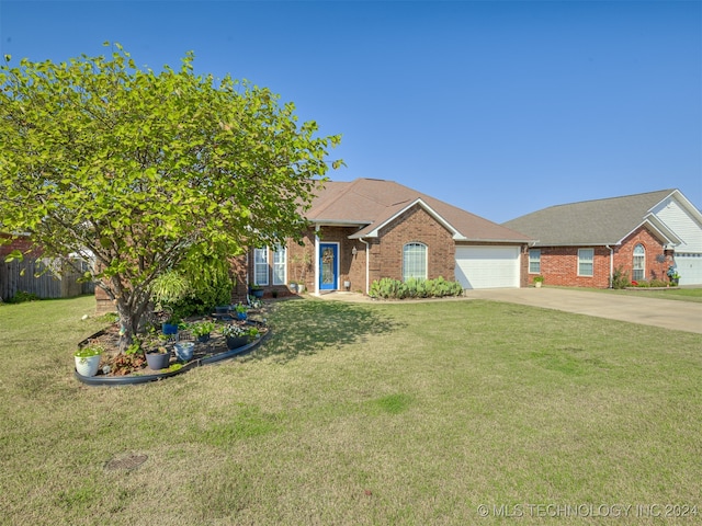 ranch-style home with a garage and a front lawn