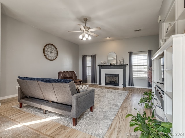 living room with hardwood / wood-style floors and ceiling fan