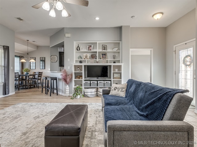 living room featuring ceiling fan and light hardwood / wood-style flooring