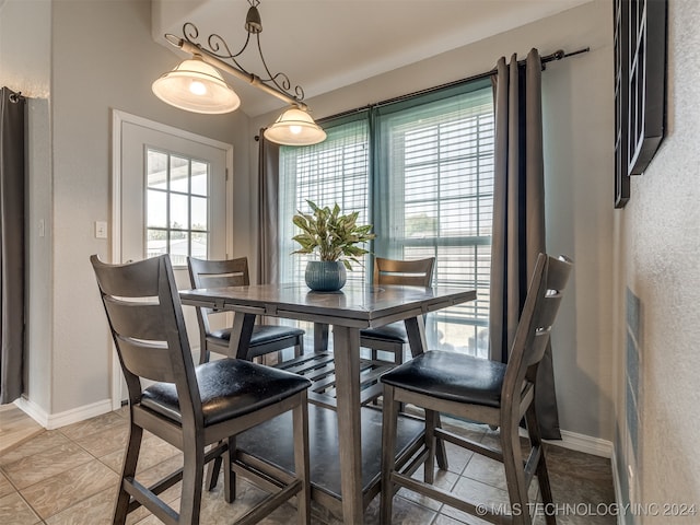 dining room with light tile patterned floors and a healthy amount of sunlight