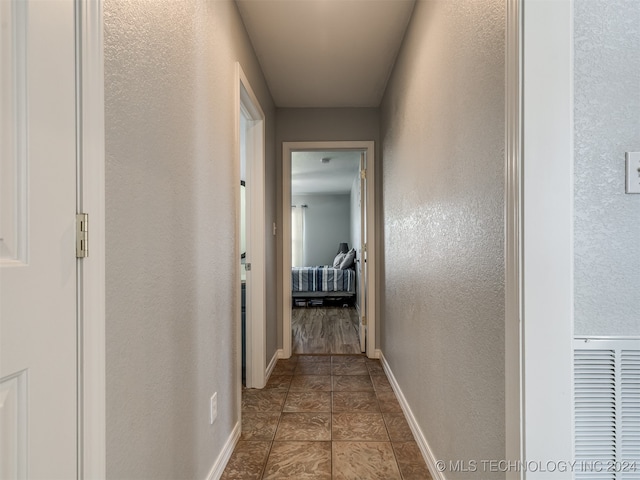 hallway featuring tile patterned flooring