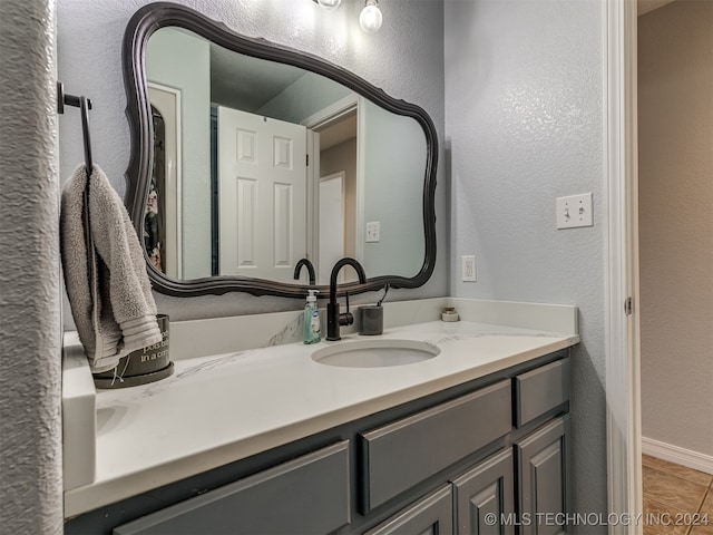 bathroom featuring tile patterned flooring and vanity