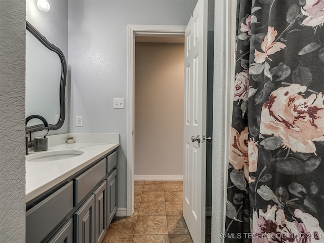 bathroom with tile patterned floors and vanity