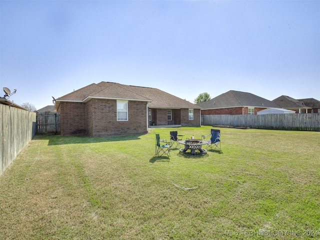 view of yard with a fire pit