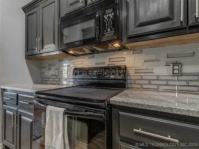 kitchen with black appliances and backsplash