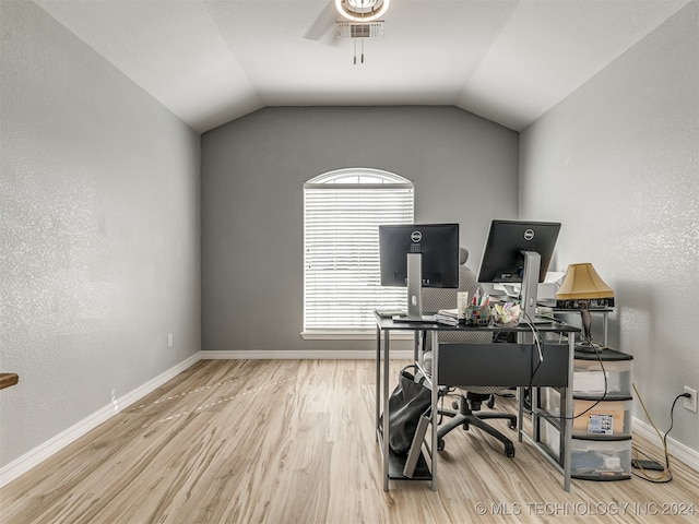 office space featuring ceiling fan, light wood-type flooring, and vaulted ceiling