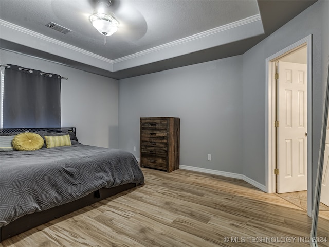 bedroom featuring ornamental molding, hardwood / wood-style flooring, and a textured ceiling