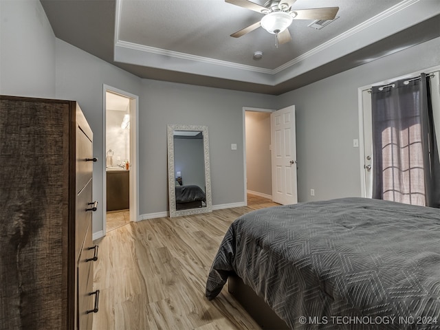 bedroom featuring ceiling fan, ornamental molding, a textured ceiling, ensuite bath, and light hardwood / wood-style floors