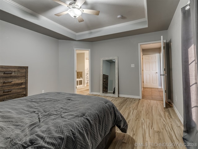 bedroom with ceiling fan, crown molding, ensuite bath, and light hardwood / wood-style floors