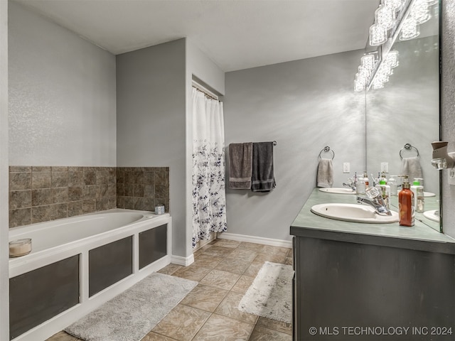 bathroom featuring a notable chandelier, a tub, and vanity