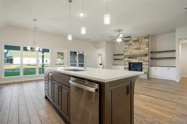 kitchen with an island with sink, light hardwood / wood-style flooring, sink, and dishwasher