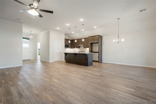 unfurnished living room featuring ceiling fan with notable chandelier, sink, and light hardwood / wood-style floors