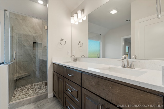 bathroom featuring vanity and a shower with shower door