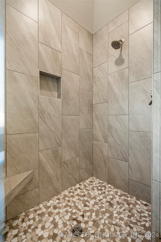 bathroom with a tile shower