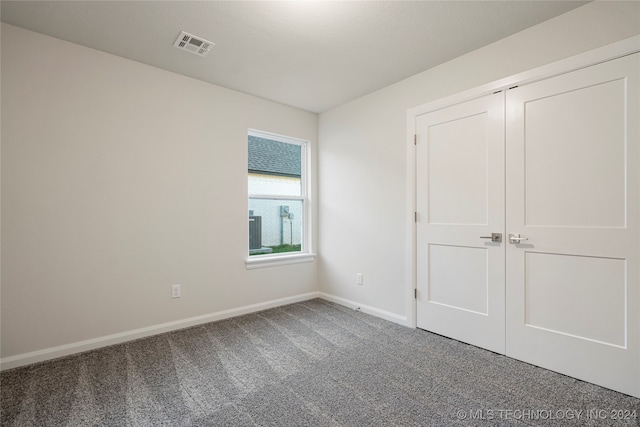 unfurnished bedroom with a closet and carpet