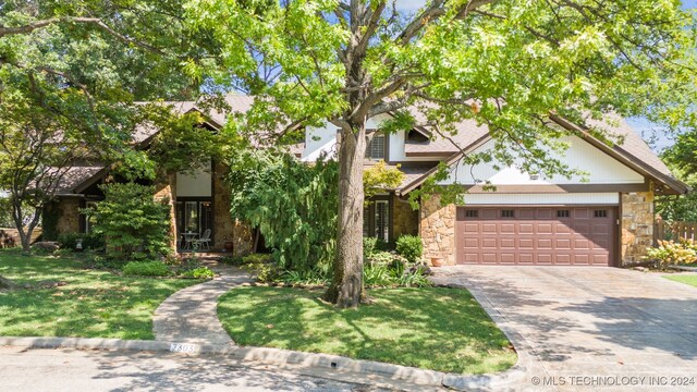 view of front of property with a front yard and a garage