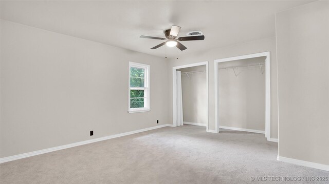 711 NW Elizabeth St, Ardmore, OK 73401 - unfurnished bedroom featuring light carpet, multiple closets, and ceiling fan