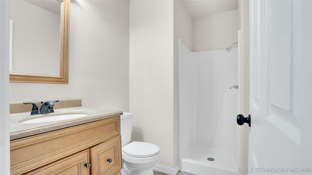 711 NW Elizabeth St, Ardmore, OK 73401 - bathroom featuring vanity, walk in shower, and toilet