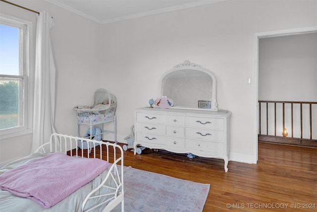 bedroom with hardwood / wood-style flooring and crown molding