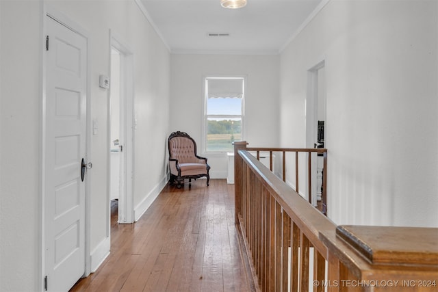 hallway featuring wood-type flooring and crown molding