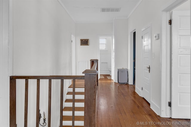 hallway with crown molding and wood-type flooring