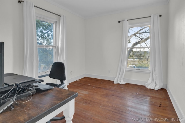 home office with dark wood-type flooring, crown molding, and a wealth of natural light