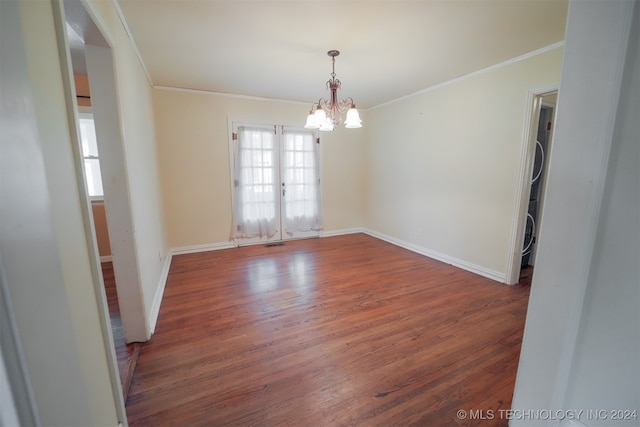 spare room with french doors, a notable chandelier, crown molding, and dark hardwood / wood-style flooring