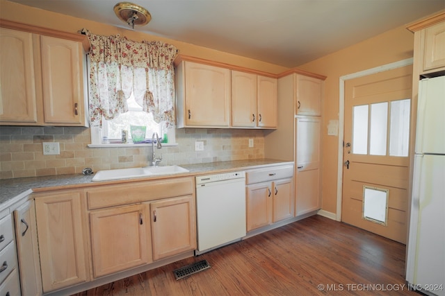 kitchen with dark hardwood / wood-style floors, white appliances, sink, light brown cabinetry, and backsplash