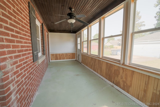 unfurnished sunroom featuring ceiling fan and wooden ceiling