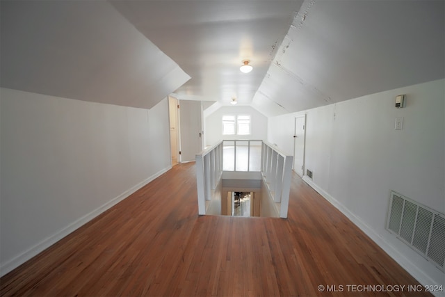 additional living space with lofted ceiling and wood-type flooring