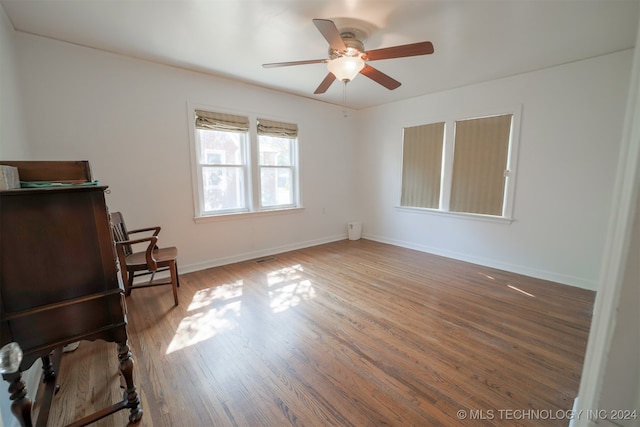 interior space with ceiling fan and dark hardwood / wood-style floors