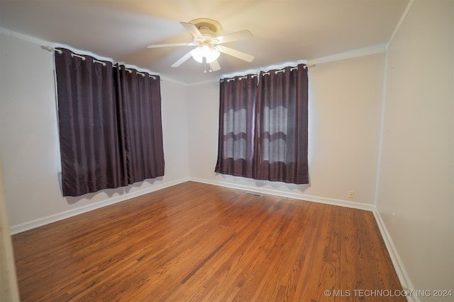 unfurnished room featuring wood-type flooring, crown molding, and ceiling fan