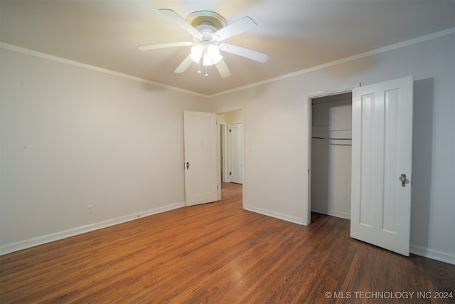 unfurnished bedroom featuring ceiling fan, a closet, crown molding, and dark wood-type flooring