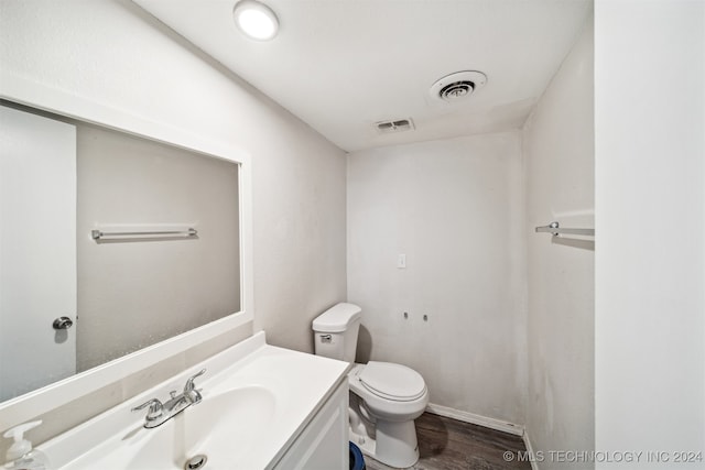 bathroom featuring vanity, toilet, and wood-type flooring