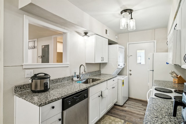 kitchen featuring sink, stacked washer / drying machine, white appliances, and white cabinetry