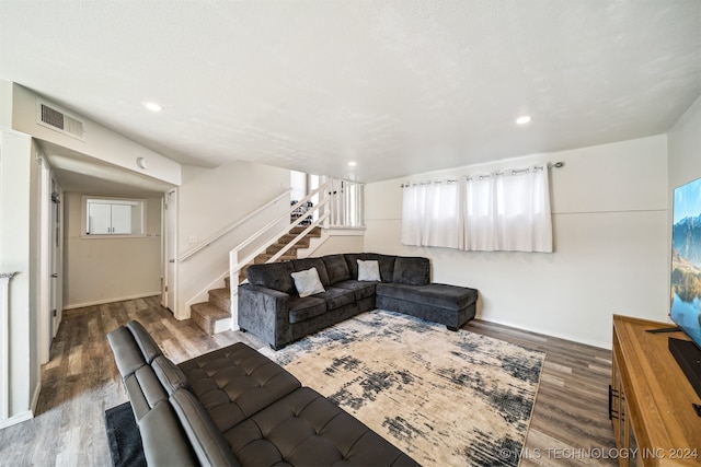 living room featuring plenty of natural light and dark wood-type flooring