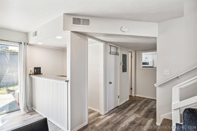 corridor with hardwood / wood-style floors