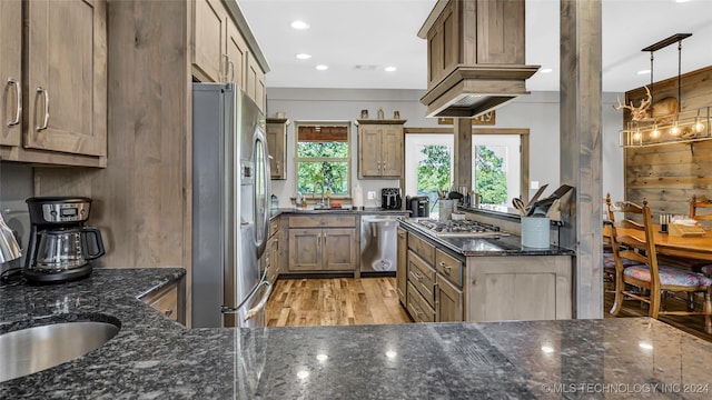 6126 Kings Rd, Ardmore, OK 73401 - kitchen with stainless steel appliances, light wood-style flooring, a sink, dark stone countertops, and recessed lighting