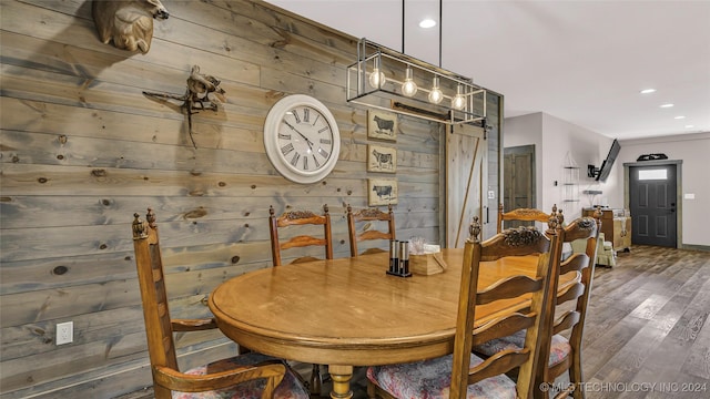 6126 Kings Rd, Ardmore, OK 73401 - dining room with wooden walls, a barn door, wood finished floors, recessed lighting, and baseboards