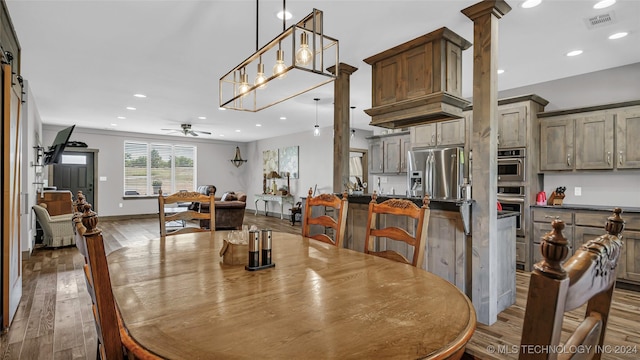 6126 Kings Rd, Ardmore, OK 73401 - dining space with hardwood / wood-style floors, recessed lighting, ceiling fan, a barn door, and baseboards