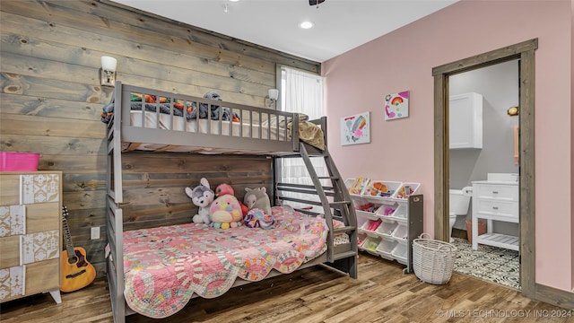 6126 Kings Rd, Ardmore, OK 73401 - bedroom with wood finished floors, ensuite bathroom, recessed lighting, and wood walls