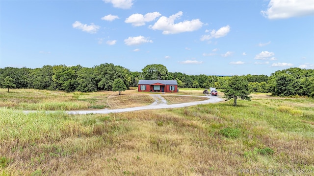 view of yard with a rural view and an outbuilding