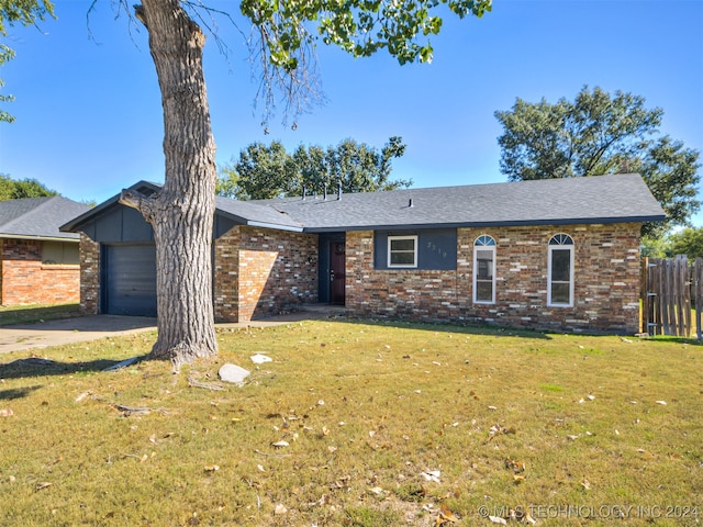 single story home with a front yard and a garage