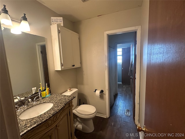 bathroom with vanity, hardwood / wood-style floors, and toilet